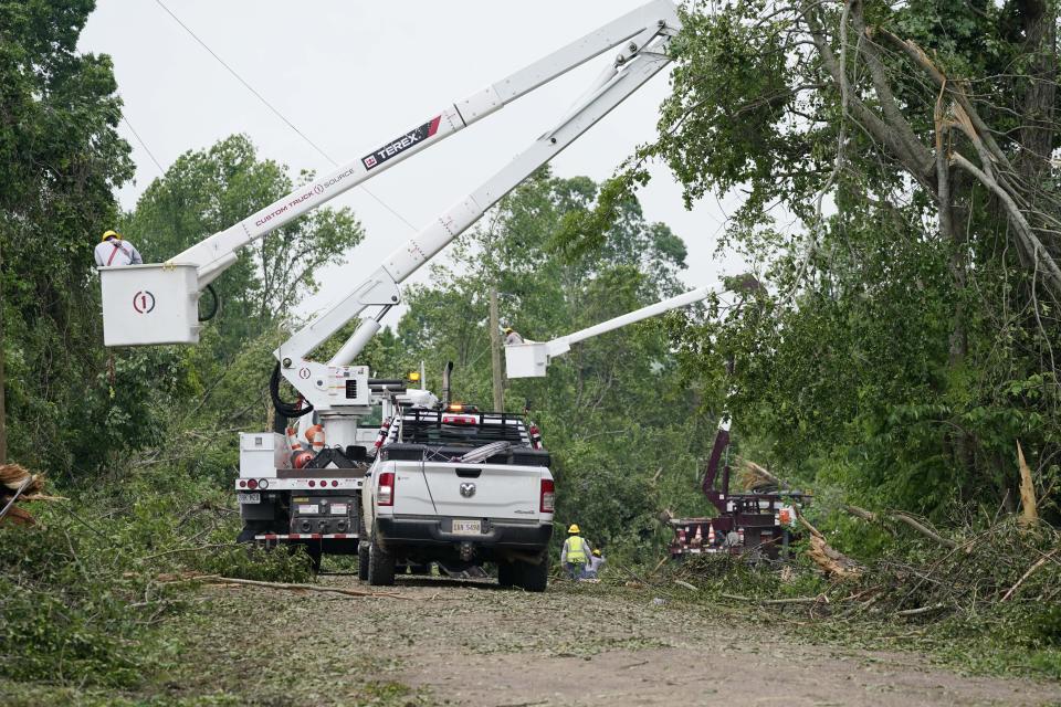 Utility linemen work on repairing power and communication lines in Yazoo County, Miss., Monday, May 3, 2021, following Sunday's tornado that destroyed a number of homes and small businesses. (AP Photo/Rogelio V. Solis)