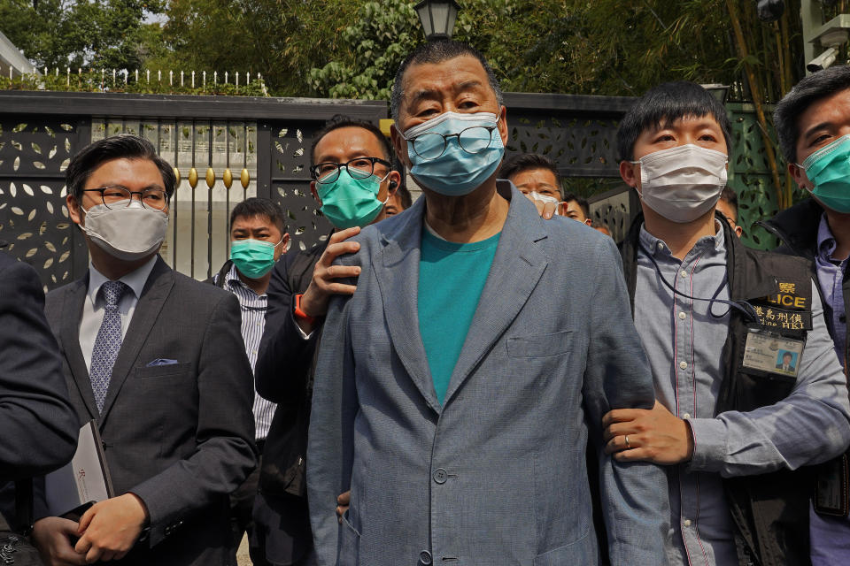 FILE - In this April 18, 2020, file photo, Hong Kong media tycoon Jimmy Lai, center, who founded local newspaper Apple Daily, is arrested by police officers at his home in Hong Kong. Lai said in an interview Wednesday that Hong Kong is dead under the new national security law. Lai, who owns popular newspaper Apple Daily, is a prominent advocate for democracy in Hong Kong. (AP Photo/Vincent Yu, File)