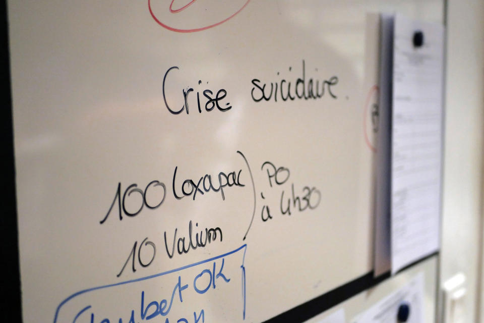 A board reads 'suicidal crisis' in the emergency ward of the Rouvray psychiatric hospital, in Rouen, western France, Wednesday, Nov. 25, 2020. Lockdowns that France has used to fight the coronavirus have come at considerable cost to mental health. Surveying points to a surge of depression most acute among people without work, in financial hardship and young adults. (AP Photo/Thibault Camus)