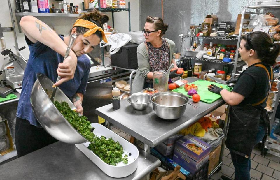 Ashley McPherson, from left, Kris Marshall of the Clovis Culinary Center, and Destiny Fenwick work in the kitchen at the Grazing Table Deli in northeast Fresno on Wednesday, May 10, 2023.