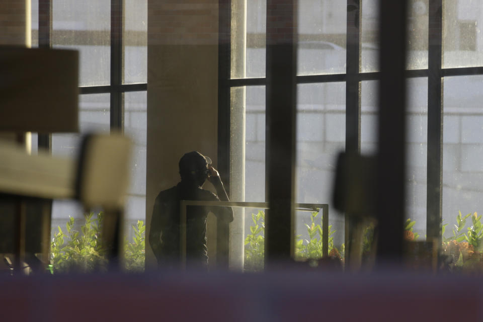 A protester uses a mobile phone at the campus of the Polytechnic University in Hong Kong, Thursday, Nov. 21, 2019. A small group of protesters refused to leave Hong Kong Polytechnic University, the remnants of hundreds who took over the campus for several days. (AP Photo/Achmad Ibrahim)