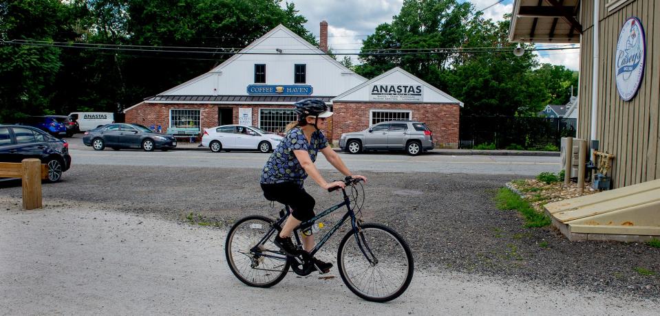 Konnie Murphy, of Wayland, passes through the Upper Charles Rail Trail in Holliston, with several lunch spots along the way, July 7, 2022.