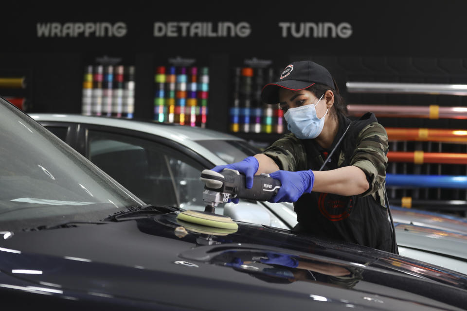 Iranian car detailer Maryam Roohani polishes a car at a detailing shop in Tehran, Iran, April 18, 2021. Roohani has battled skeptics and stereotypes to live out her dream of working as a professional detailer. The auto industry remains male-dominated around the world, let alone in the tradition-bound Islamic Republic. Still Iranian women, especially in the cities, have made inroads over the years. (AP Photo/Vahid Salemi)