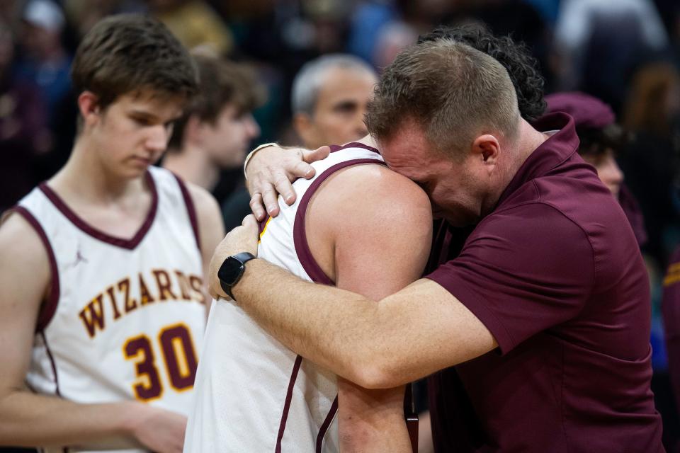 Windsor's head coach Jon Rakiecki comforts Johnathan Reed after losing a close class 5A state championship game against Mesa Ridge at the Denver Coliseum on Saturday.