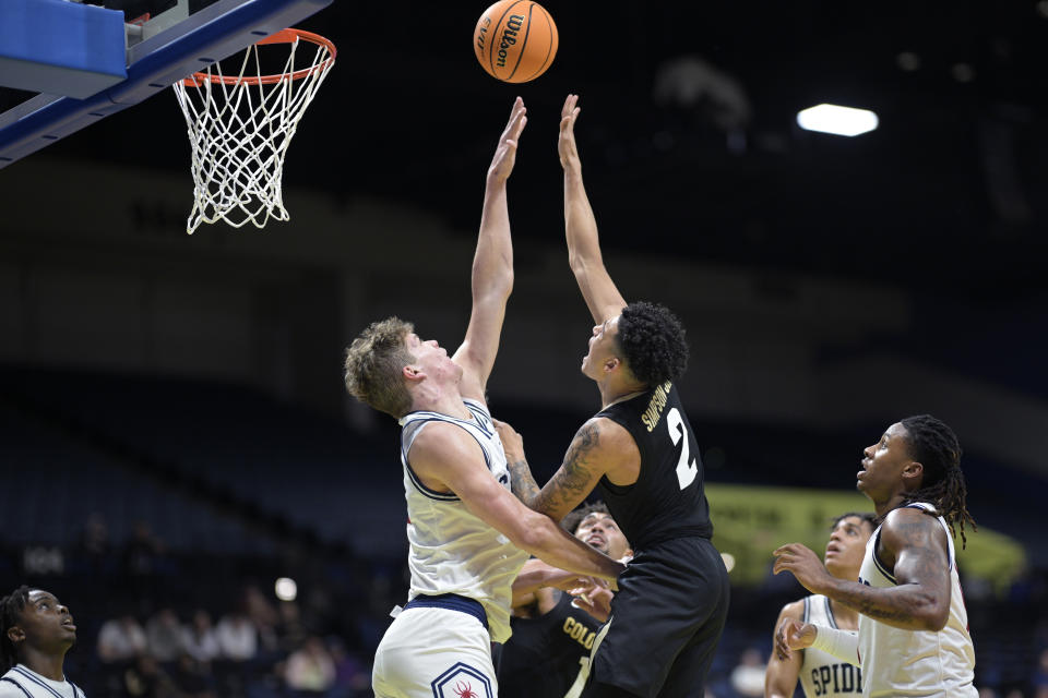 Colorado guard KJ Simpson (2) shoots in front of Richmond center Mike Walz, center left, during the second half of an NCAA college basketball game, Monday, Nov. 20, 2023, in Daytona Beach, Fla. (AP Photo/Phelan M. Ebenhack)