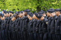 Police officers line the street as the funeral procession of New York police officer Anastasios Tsakos leaves the St. Paraskevi Greek Orthodox Shrine Church, Tuesday, May 4, 2021, in Greenlawn, N.Y. Tsakos was at the scene of an accident on the Long Island Expressway when he was struck and killed by an allegedly drunk driver a week ago. (AP Photo/Mark Lennihan)