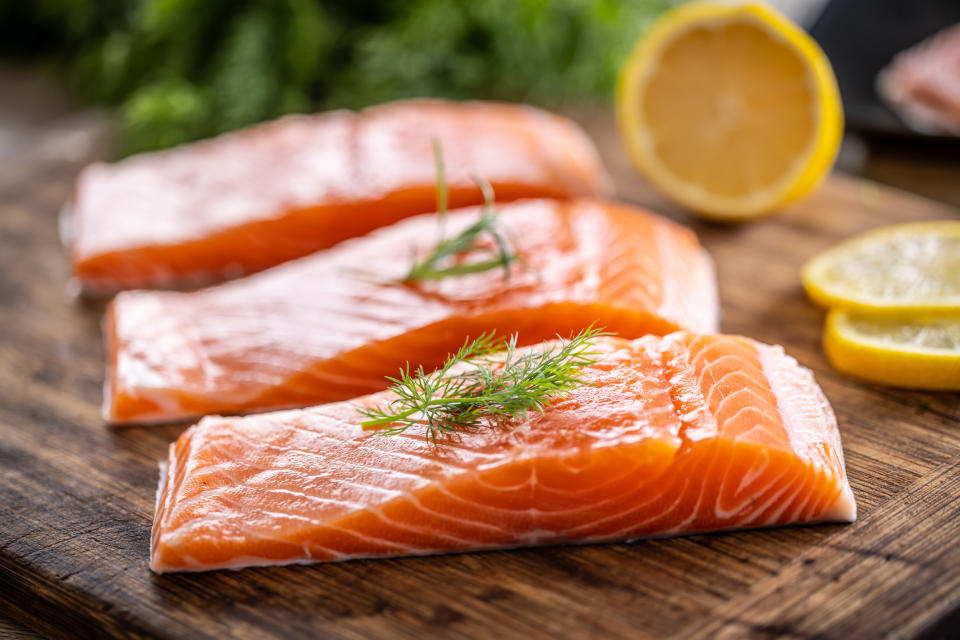 Salmon fillets on a cutting board.