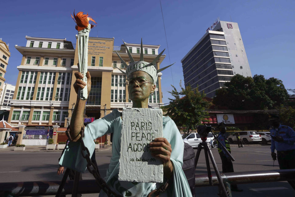 Cambodian-American lawyer Theary Seng, dressed in the Lady Liberty stands outside Phnom Penh Municipal Court in Phnom Penh, Cambodia, Tuesday, June 14, 2022. Cambodian-American lawyer Theary Seng, dressed in the Lady Liberty talks to the media outside Phnom Penh Municipal Court in Phnom Penh, Cambodia, Tuesday, June 14, 2022. Cambodian court expected to deliver verdict on mass treason trial involving Theary Seng, and dozens of other defendants who were former members of the dissolved opposition party. (AP Photo/Heng Sinith)