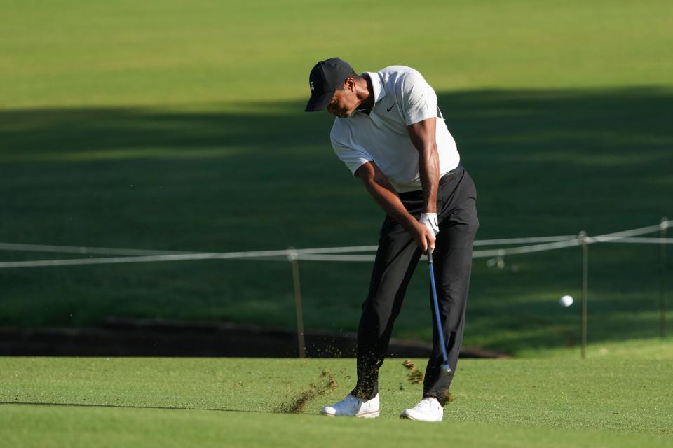 Tiger Woods hits from the fairway on the 10th hole during a practice round for the PGA Championship golf tournament at Southern Hills Country Club.