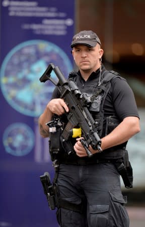 Police officer is seen outside the Arndale shopping centre after several people were stabbed in Manchester