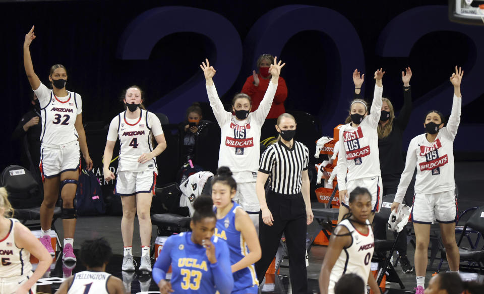 The Arizona bench reacts after a teammate's 3-point shot during the second half of an NCAA college basketball game against UCLA in the semifinals of the Pac-12 women's tournament Friday, March 5, 2021, in Las Vegas. (AP Photo/Isaac Brekken)