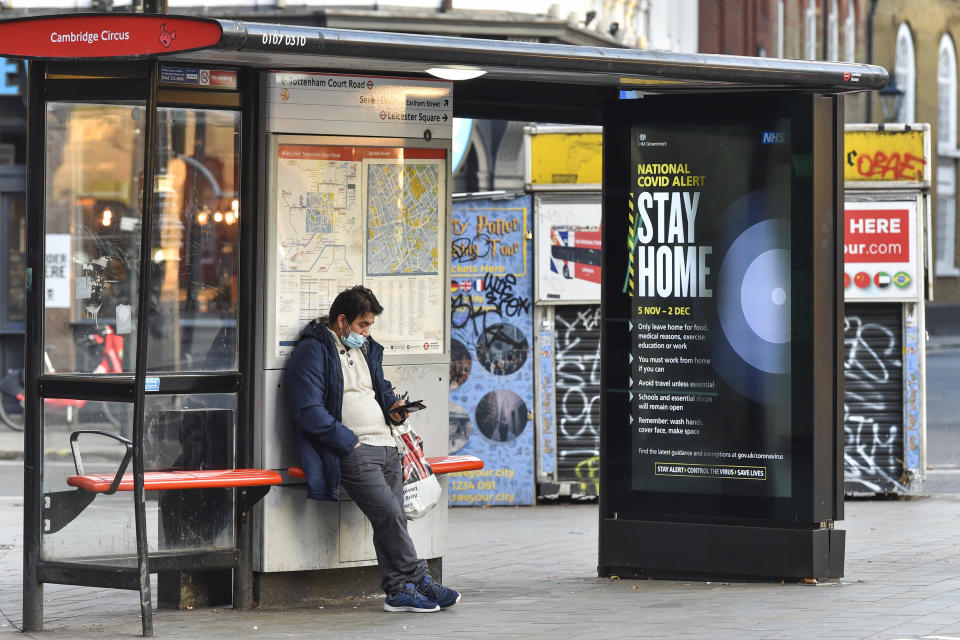  A man using his phone at a Bus Stop in Cambridge Circus, where a Government Covid 19 level alert saying ‘’Stay Home” displays on an electronic screen. England has entered into the 2nd Lockdown due to the Pandemic. (Photo by Dave Rushen / SOPA Images/Sipa USA) 