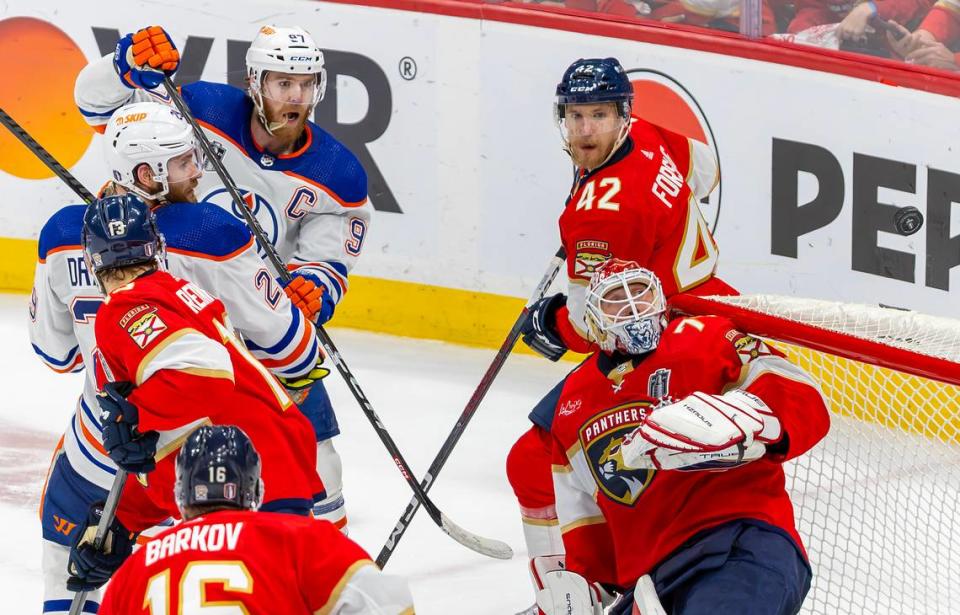 Florida Panthers goaltender Sergei Bobrovsky (72) defends teammate defenseman Gustav Forsling (42) deflects a shot Edmonton Oilers center Connor McDavid (97) during the third period of Game 7 of the NHL Stanley Cup Final at the Amerant Bank Arena on Monday, June 24, 2024, in Sunrise, Fla.