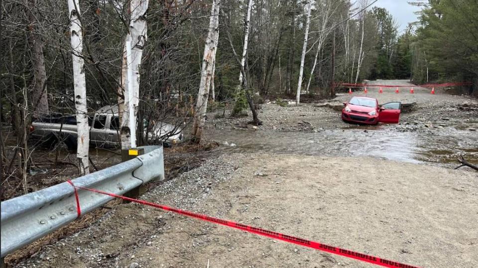 Two cars were left under water in Chertsey, Que, after torrential rain washed out part of a local road.  (Raphael Drouin/Radio Canada - image credit)