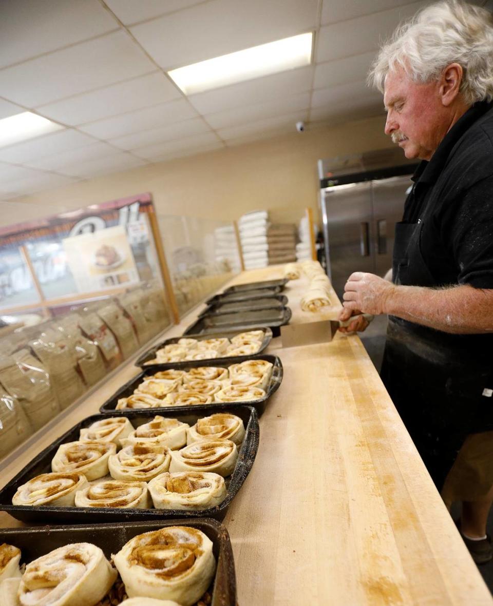 Old West Cinnamon Rolls co-owner Joe Parkhurst starts with a huge layer of dough, before adding margarine, sugar and cinnamon. He then rolls up the dough and slices it to make the rolls. They are left to rise and then baked. The shop has been a Pismo Beach institution since 1981.