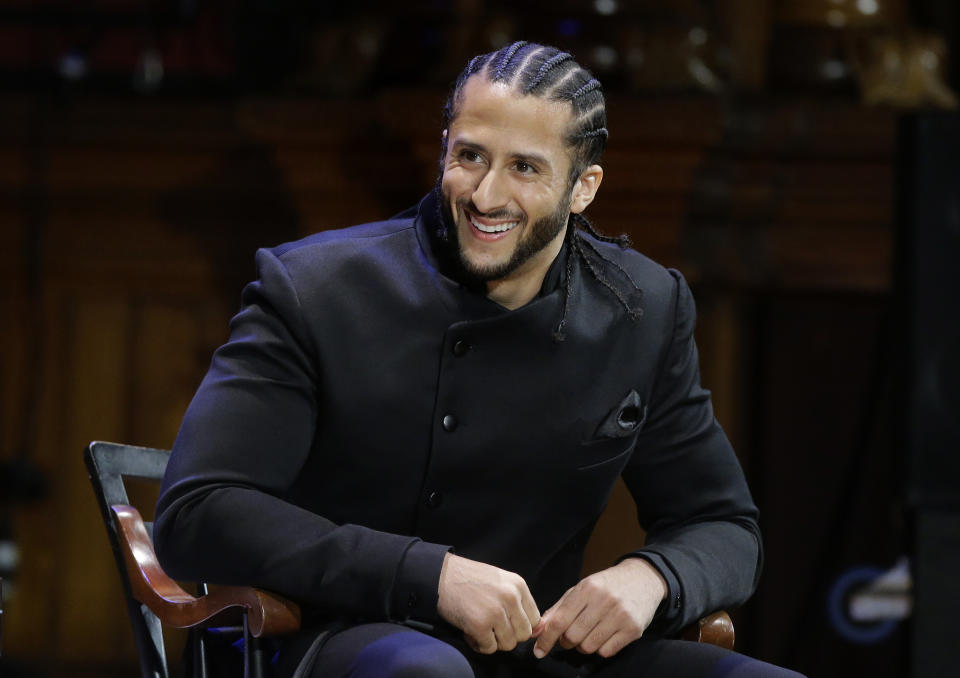 FILE - In this Oct. 11, 2018, file photo, former NFL football quarterback Colin Kaepernick smikes on stage during W.E.B. Du Bois Medal ceremonies at Harvard University, in Cambridge, Mass. Colin Kaepernick wants to play in the NFL, even if he has to compete to get on the field. A source close to Kaepernick told The Associated Press on Friday: “Colin has always been prepared to compete at the highest level and is in the best shape of his life.” Kaepernick released a video earlier this week saying: “5 a.m. 5 days a week. For 3 years. Still Ready.” (AP Photo/Steven Senne, File)