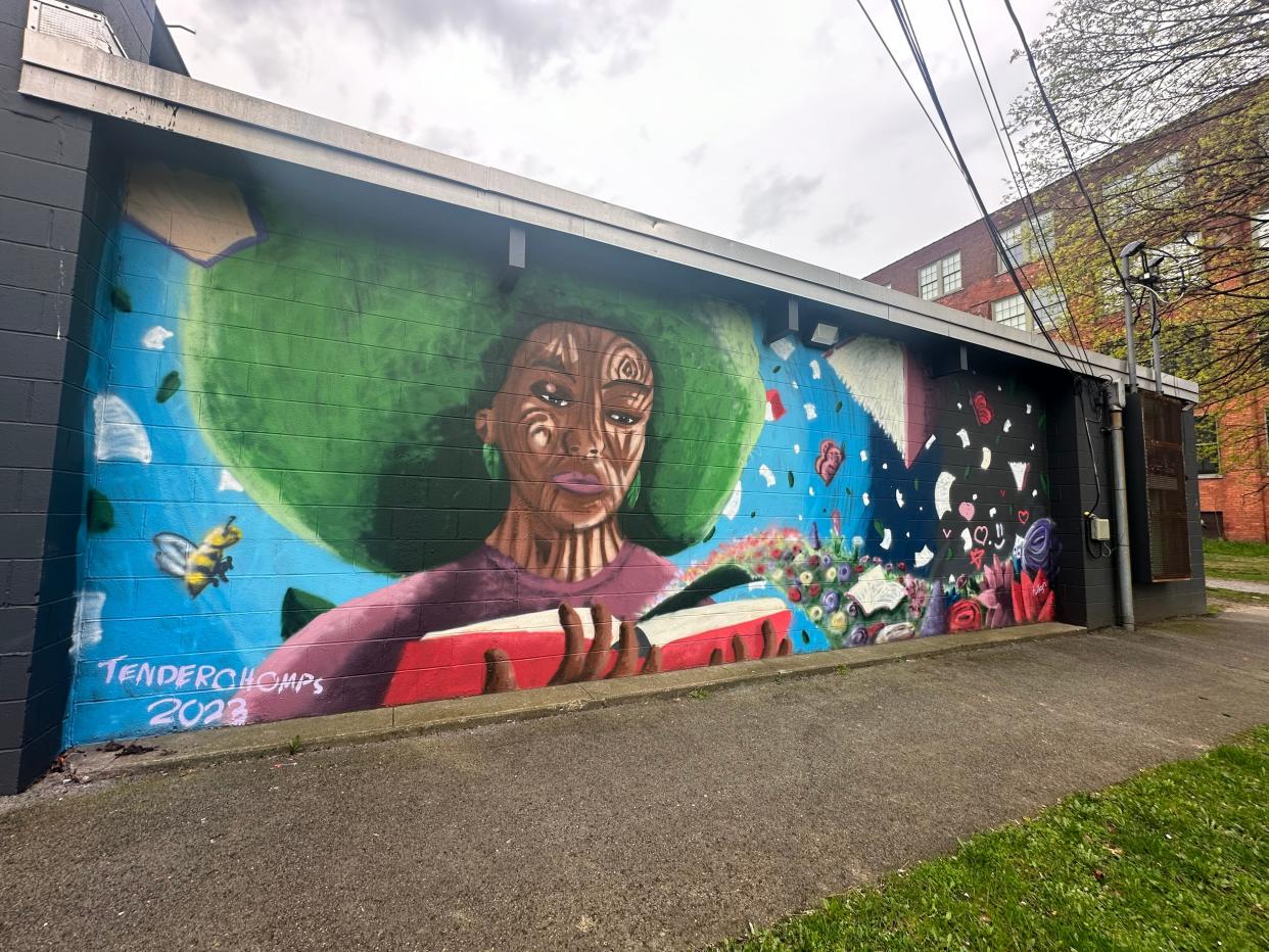 To find the newest mural at Avenue D R-Center at 200 Avenue D go around to the back of center, near the fields and playground. Artists Hilleyri Binet and Tim Lynch, known professionally as Tenderchomps, created a mural that highlights the power of reading and exploration.