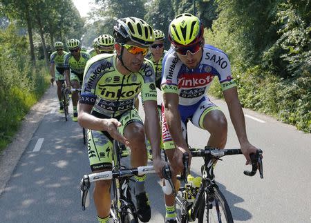 Tinkoff-Saxo team rider Alberto Contador of Spain (L) talks with his team mate Peter Sagan of Slovakia during a team training session in Utrecht, Netherlands, July 2, 2015. REUTERS/Stefano Rellandini