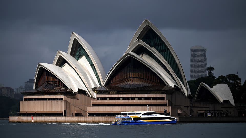 A passenger ferry makes its way past the Sydney Opera House on May 8, 2024. Arup consulted on the structural engineering of the venue during its construction. - Saeed KHAN/AFP/Getty Images