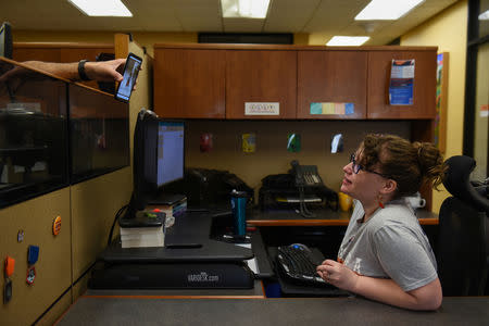 Lauren Hoffmann, 29, a college program manager, interacts with a colleague at work in San Antonio, Texas, U.S., February 15, 2019. REUTERS/Callaghan O'Hare