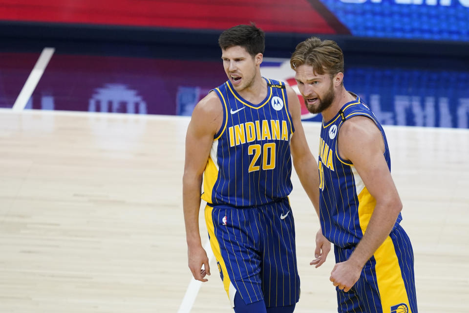 Indiana Pacers' Doug McDermott (20) and Domantas Sabonis (11) react during the first half of the team's NBA basketball Eastern Conference play-in game against the Charlotte Hornets, Tuesday, May 18, 2021, in Indianapolis. (AP Photo/Darron Cummings)