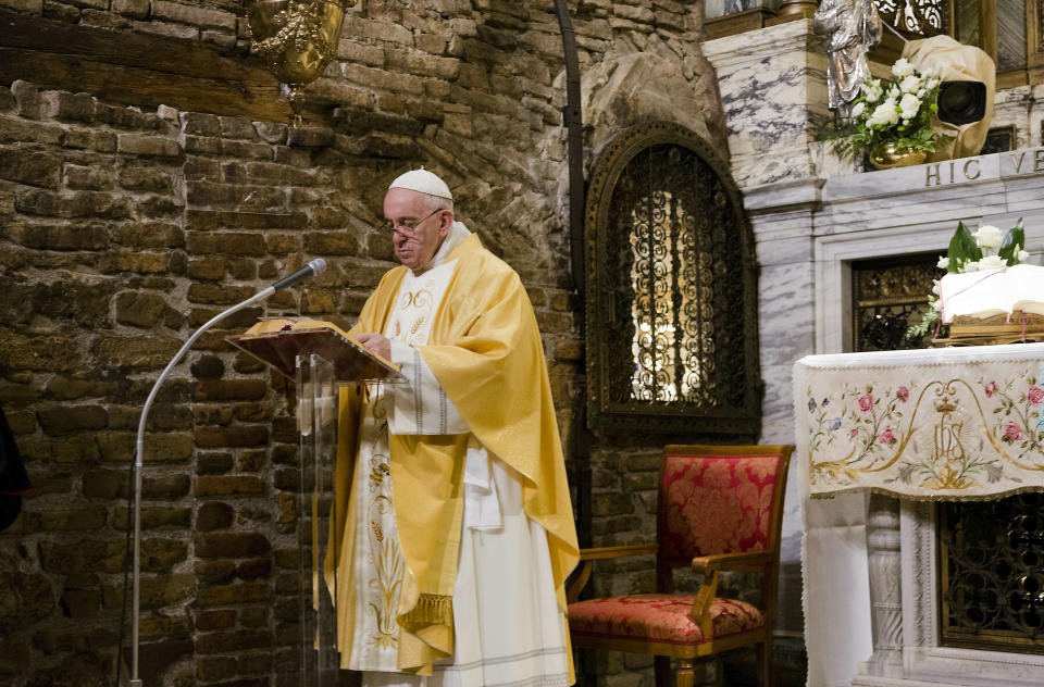 Pope Francis prays inside the shrine containing a small house traditionally venerated as the house of Mary, and believed miraculously transplanted from the Holy Land inside the Basilica of Our Lady of Loreto, in central Italy, where Francis is paying a one-day visit, Monday, Mar. 25, 2019. The pope chose Loreto to sign the Post-Synodal Exhortation of last October's Synod of Bishops. (AP Photo/Domenico Stinellis)