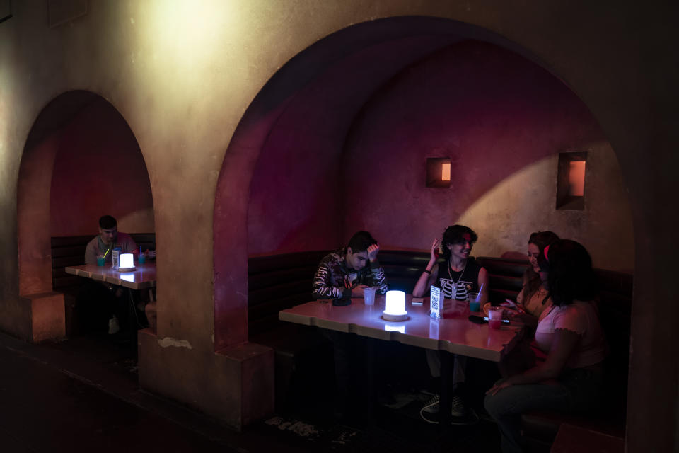 Customers chat at Scum and Villainy Cantina, a bar located on Hollywood Blvd, in Los Angeles, Tuesday, May 4, 2021. California has the lowest infection rate in the country. Los Angeles County, which is home to a quarter of the state's nearly 40 million people and has endured a disproportionate number of the state's 60,000 deaths, didn't record a single COVID-19 death Sunday or Monday, which was likely due to incomplete weekend reporting but still noteworthy. (AP Photo/Jae C. Hong)