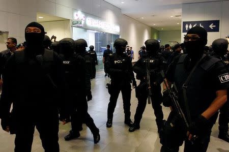 Armed police stand guard as Indonesian Siti Aisyah and Vietnamese Doan Thi Huong, who are on trial for the killing of Kim Jong Nam, the estranged half-brother of North Korea's leader, revisit Menara Clinic at Kuala Lumpur International Airport Two in Sepang, Malaysia October 24, 2017. REUTERS/Lai Seng Sin