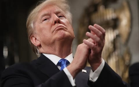 U.S. President Donald Trump applauds while delivering a State of the Union address  - Credit: Win McNamee/Getty