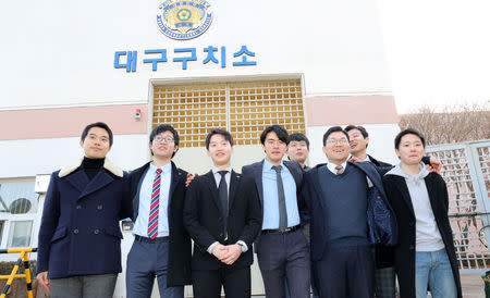 South Korean conscientious objectors pose for photographs after being released from Daegu detention center in Daegu, South Korea, November 30, 2018. Yonhap via REUTERS