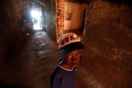 Senegalese boy walks from the 'Door of No Return' as he visits the 'Maison Des Esclaves' slaves house, a gathering point from where slaves were shipped west in the 1700s and 1800s, at Goree Island