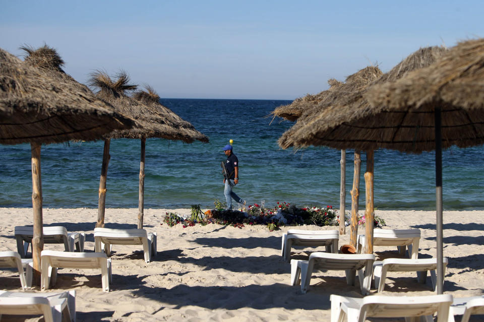 Massacre: A policeman patrols the beach after the terrorist attack in Sousse: Steve Parsons / PA Wire