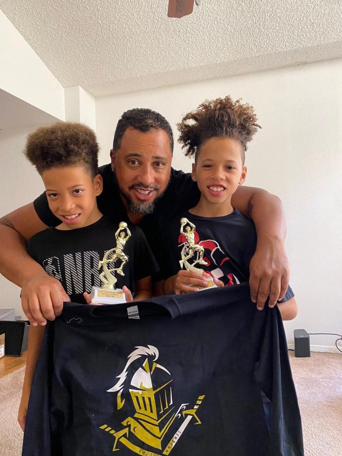 Arizona Republic columnist Greg Moore, shown with his twin sons in May of 2021, has a new perspective on sports and parenting.