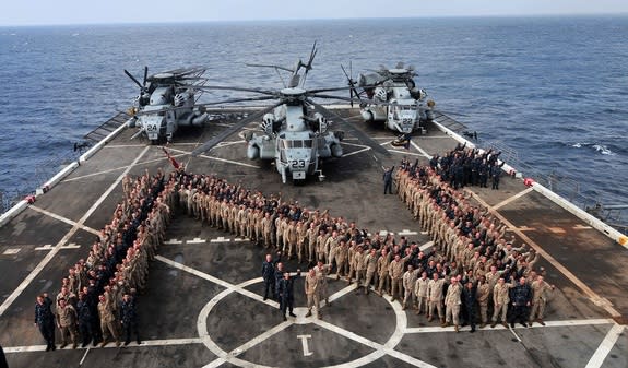 The USS Mesa Verde deployed to help storm recovery efforts after Hurricane Sandy hit the U.S. Here sailors and Marines stand in a Navy 'N' during the making of a spirit video for the making of a spirit video for the Navy versus Army game.