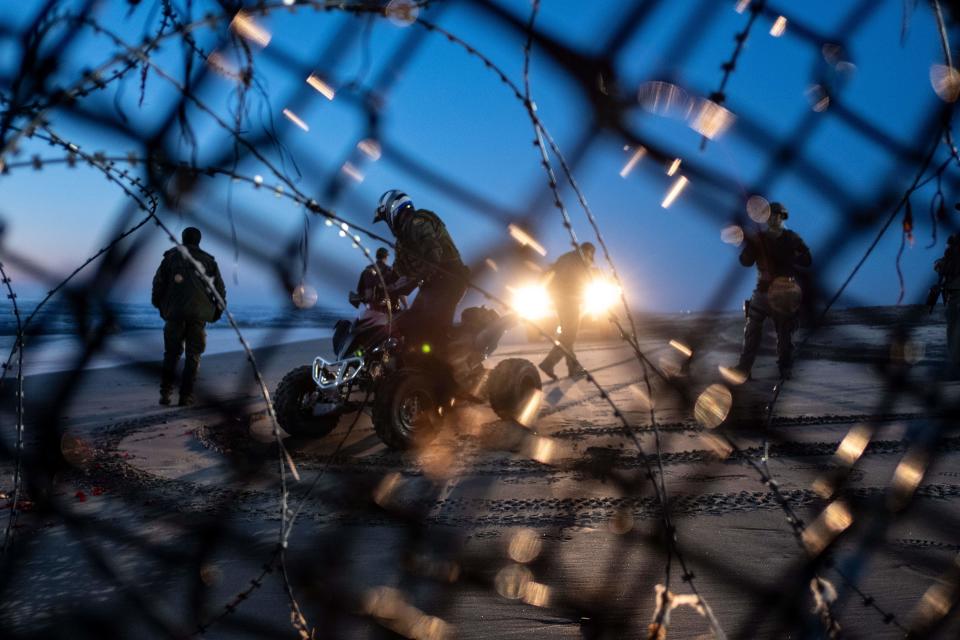 Border patrol agents look on after migrants traveling in the Central American Caravan crossed through the Mexico-U.S. border fence from Tijuana to San Diego County, as seen from Playas de Tijuana, Baja California state, Mexico, on Dec. 13, 2018. (Photo: Guillermo Arias/AFP/Getty Images)