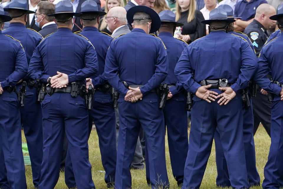 FILE - In this Friday, Sept. 25, 2020 file photo, troopers gather during the burial services for Louisiana State Police Master Trooper Chris Hollingsworth in West Monroe, La. Hollingsworth died in a single-car crash hours after he learned he had been fired for his role in the in-custody death of Ronald Greene. As the Louisiana State Police reel from a sprawling federal investigation into the deadly 2019 arrest of Greene, a Black motorist, and other beating cases, dozens of current and former troopers tell The Associated Press of an entrenched culture at the agency of impunity, nepotism and in some cases outright racism. (AP Photo/Rogelio V. Solis)