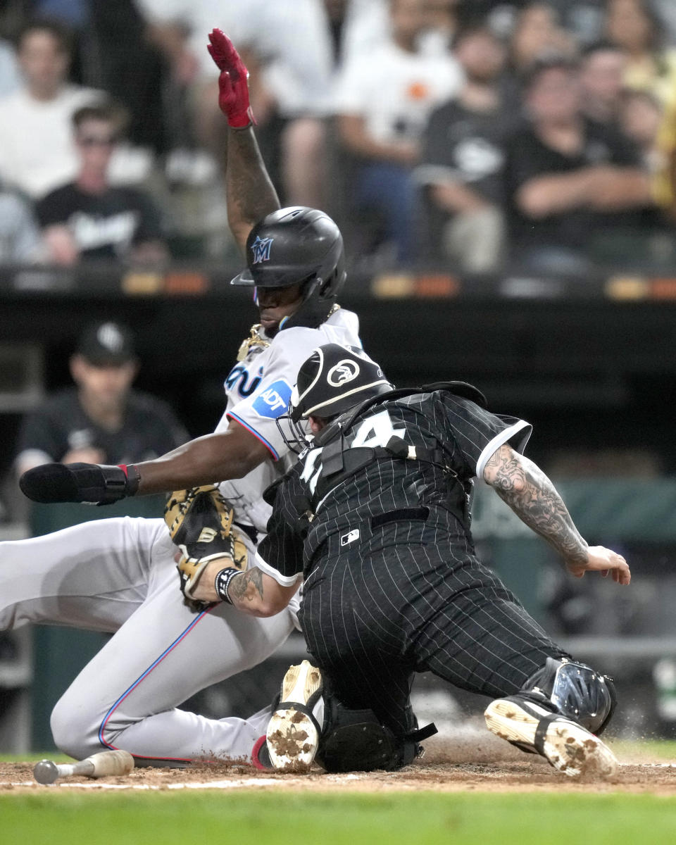 Chicago White Sox catcher Yasmani Grandal tags out Miami Marlins' Jorge Soler at home during the sixth inning of a baseball game Friday, June 9, 2023, in Chicago. (AP Photo/Charles Rex Arbogast)