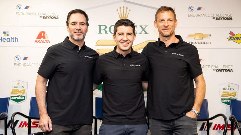 A photo of Jimmie Johnson, Mike Rockenfeller, and Jenson Button at an event in Florida. 