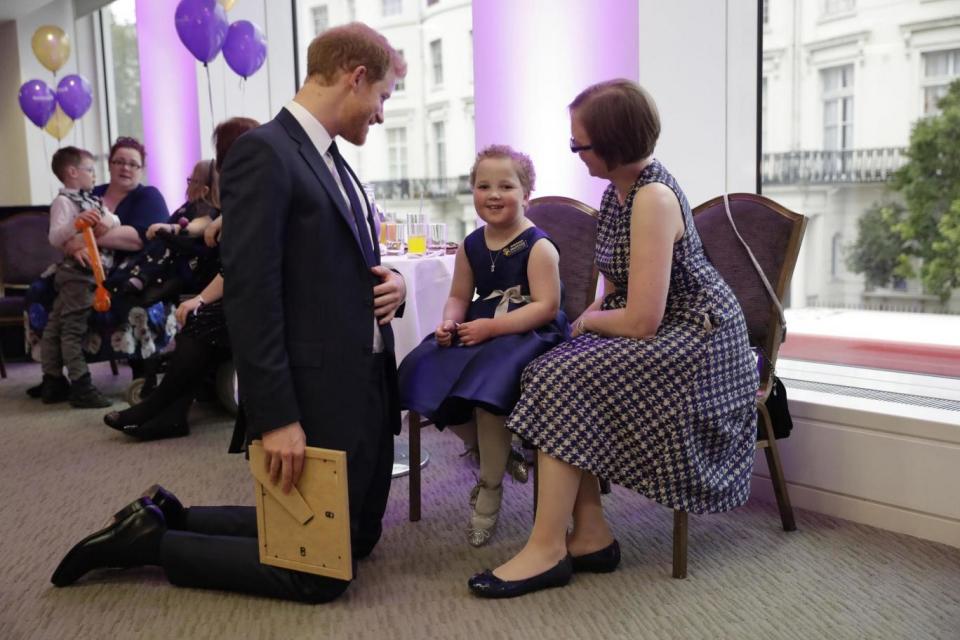 Prince Harry meets Erin Cross, aged 7, the winner of the Inspirational Child Award aged 4-6. (PA)