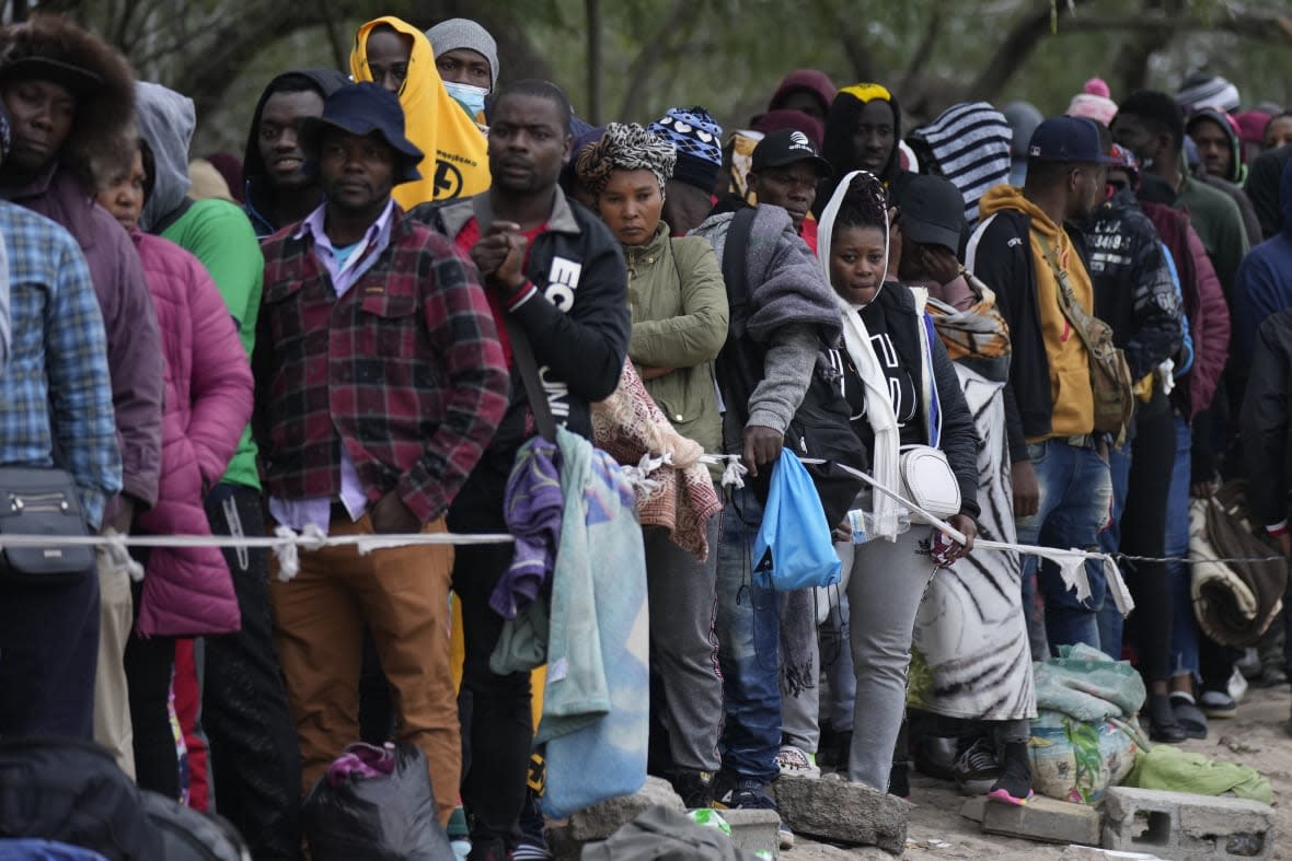 Haitian migrants who hope to apply for asylum in the U.S. wait to register their names on a list made by a religious organization in Reynosa, Mexico, Dec. 21, 2022, on the other side of the border with McAllen, Texas. (AP Photo/Fernando Llano, File)