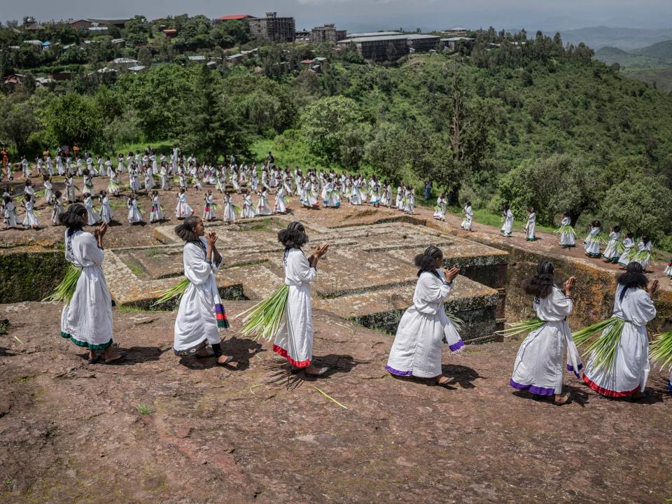 Worshippers in white seen around the top of the building.