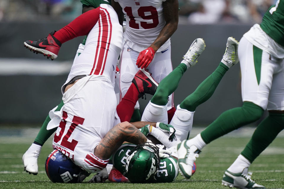 New York Jets cornerback Michael Carter II (30) is tackled by New York Giants guard Jon Feliciano (76) in the first half of a preseason NFL football game, Sunday, Aug. 28, 2022, in East Rutherford, N.J. (AP Photo/Julia Nikhinson)