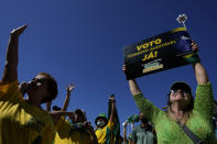 A supporter of Brazil's President Jair Bolsonaro carries a sign that reads in Portuguese "Printed and auditable vote," during a pro-Bolsonaro rally at the Esplanade of Ministries, in Brasilia, Brazil, Sunday, Aug. 1, 2021. Political backers of President Bolsonaro have called for nationwide rallies to express their support for the embattled leader and his call for adding printouts to the electronic voting system. (AP Photo/Eraldo Peres)