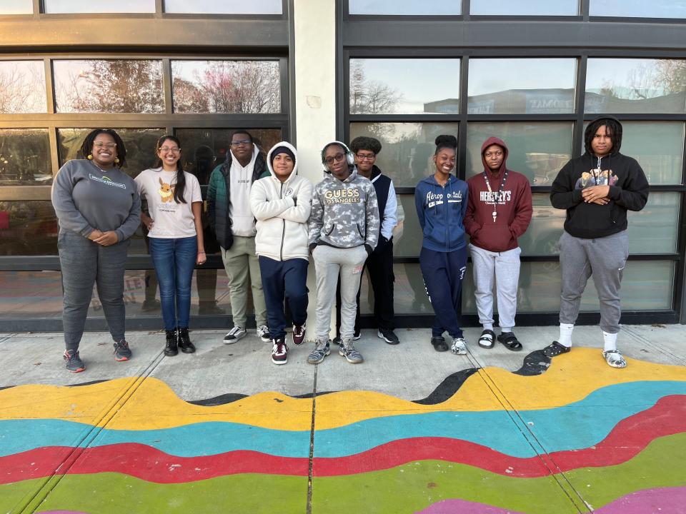 From left, Micah Jumpp, a Trolley Barn Gallery fellow alongside PK B.A.Y. youth leaders Andrea Martinez Lopez, Peter Sealy, Edwin Gomez-Perez, Raheem Webb, Avi Reeves, Phyenix Young-White, Jazylo Alexis-Taylor and Xayvion White.