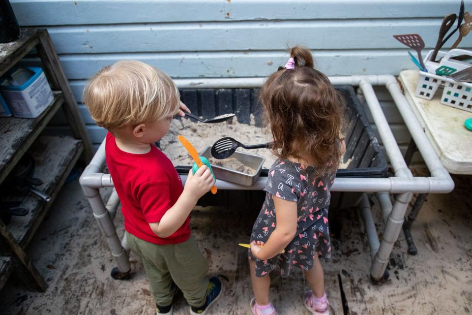 Children play outdoors at Creative Preschool on Tuesday, April 25, 2023. 