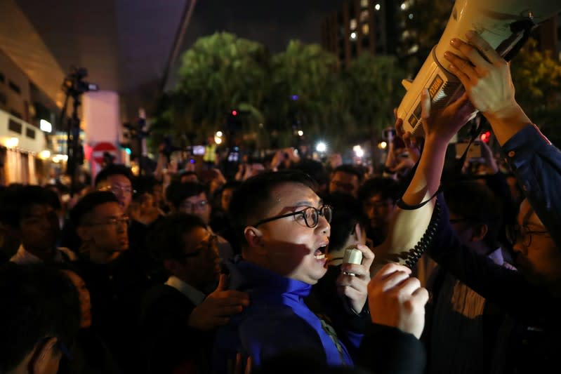 A pro-democratic district councilor-elect addresses pro-democracy protesters outside the Polytechnic University (PolyU) in Hong Kong