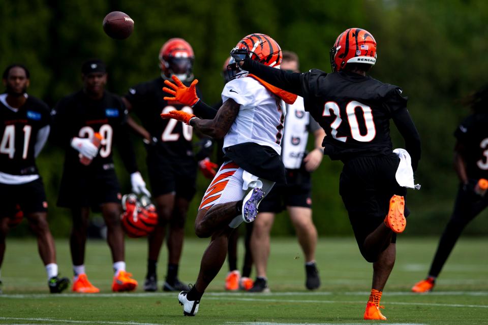 Cincinnati Bengals wide receiver Ja'Marr Chase (1) catches a pass as Cincinnati Bengals cornerback Eli Apple (20) guards him during Cincinnati Bengals preseason training camp at the Paul Brown Stadium training facility in Cincinnati on Thursday, July 28, 2022.