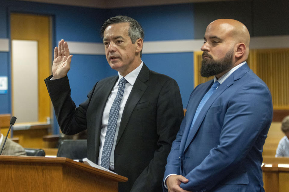 Attorney Scott Grubman, right, stands with his client, Kenneth Chesebro as Chesebro is sworn in during a plea deal hearing, Friday, Oct. 20, 2023, at the Fulton County Courthouse in Atlanta. Chesebro, who was was charged alongside former President Donald Trump and 17 others with violating the state's anti-racketeering law in efforts to overturn Trump's loss in the 2020 election in Georgia, pleaded guilty to a felony just as jury selection was getting underway in his trial. (Alyssa Pointer/Pool Photo via AP)