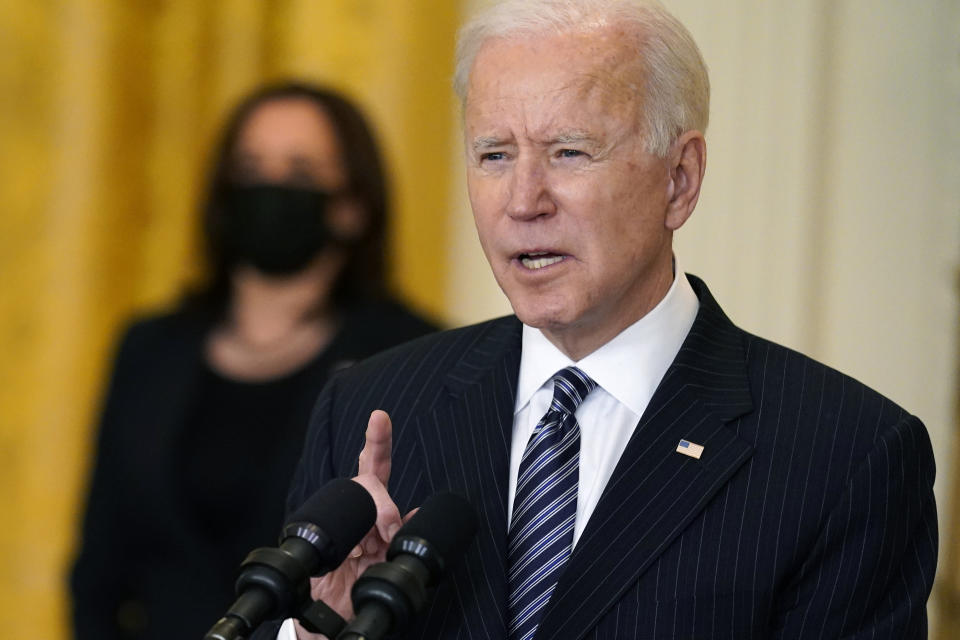 President Joe Biden speaks about COVID-19 vaccinations, from the East Room of the White House, Thursday, March 18, 2021, in Washington, as Vice President Kamala Harris listens. (AP Photo/Andrew Harnik)