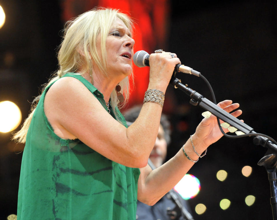 FILE - In this Sept. 21, 2013 file photo, Pegi Young & The Survivors perform with Neil Young during the Farm Aid 2013 concert at Saratoga Performing Arts Center in Saratoga Springs, N.Y. Young, who with fellow musician and then-husband Neil Young helped found the Bridge School for children with speech and physical impairments, has died. Young died of cancer Tuesday, Jan. 1, 2019, in California, according to spokeswoman Michelle Gutenstein-Hinz. She was 66. (AP Photo/Hans Pennink, File)